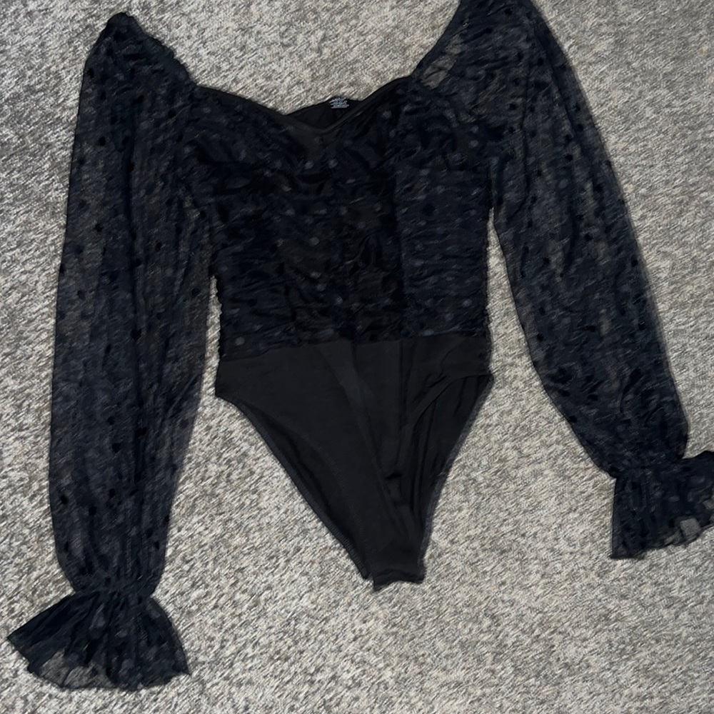 black body suit with sheer sleeves